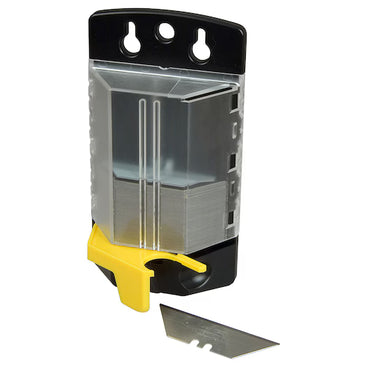 The STANLEY® FATMAX® Induction Utility Blade x100 Dispenser, in black and transparent plastic with a yellow lever, stands upright holding multiple heavy-duty blades. A single STANLEY utility blade is placed in front of the dispenser.