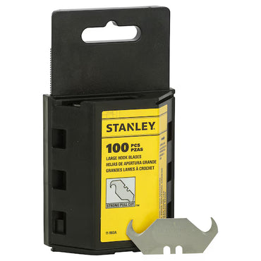 A black Stanley dispenser holds 100 large 19mm hook blades (50mm length), ideal for carpet cutting. One silver blade is shown in front, and the yellow-and-black packaging features Stanley branding and a blade illustration.