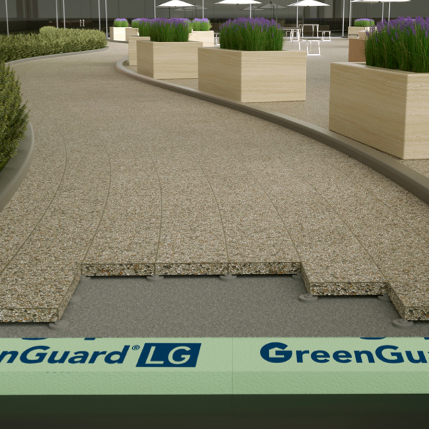 The image depicts a pathway under construction, showcasing layers of materials including KINGSPAN 3 in. x 4 ft. x 8 ft. R-15 Foam Board Insulation for improved energy efficiency. In the background, planters with purple flowers and a seating area with umbrellas add charm to the scene.