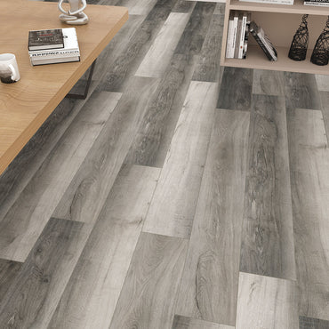 MSI Cyrus Bracken Hill Luxury Vinyl Planks (23.77 sqft/box) feature a gray wood-look and click-lock installation, creating a modern, textured floor. A light wood coffee table and wall shelves with decor complete the stylish living area.