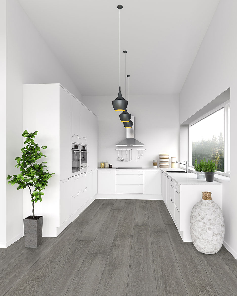 Modern white kitchen with MSI XL Cyrus Grayton Luxury Vinyl Planks (22.44 sq ft/box), grey wood look, waterproof flooring, pendant lights, potted plant, large vase, built-in appliances, and wide window for natural light.