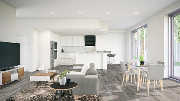 Modern open-plan living space featuring a grey sofa, coffee table, TV, dining area with glass table and four chairs, and a white kitchen with bar stools. Large windows highlight MSI XL Cyrus Mezcla Luxury Vinyl Planks flooring.