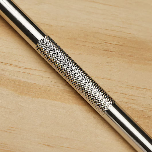 A close-up of the STANLEY Hobby Knife featuring a textured, crosshatched grip and replaceable blades, placed on a light wooden surface.