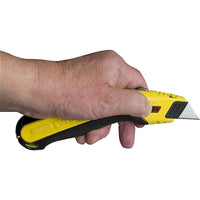 A hand holds a STANLEY® FATMAX® Retractable Utility Knife by STANLEY, blade extended, ready for use against a white background.