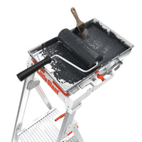 A black paint roller and brush sit in a tray of black paint atop a LITTLE GIANT 15165-001 Paint Pro IAA 5 ft. aluminum stepladder with tool tray.