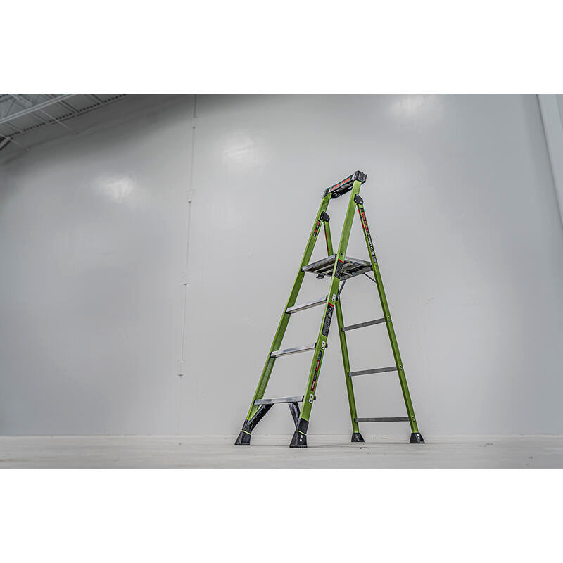 A LITTLE GIANT 15396-001 MightyLite IA 6 ft. 300 lb. rated fiberglass stepladder stands open on a white floor, set against a plain light gray wall in a brightly lit, spacious room.