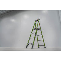 A LITTLE GIANT 15396-001 MightyLite IA 6 ft. 300 lb. rated fiberglass stepladder stands open on a white floor, set against a plain light gray wall in a brightly lit, spacious room.