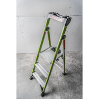 A LITTLE GIANT 15395-001 MightyLite IA 5 ft. fiberglass stepladder (300 lb. rating) stands open on a concrete floor in front of a partially finished drywall wall.