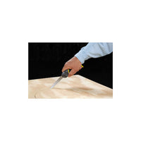 A person in a light blue sleeve uses the STANLEY 3-in-1 Multi-Purpose Saw to cut a curved line into light wood, with the black background highlighting the tool’s precision and versatility.