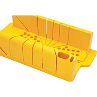 The STANLEY® Clamping Mitre Box with Saw by STANLEY is a bright yellow plastic tool with angled slots and circular holes for precise wood cutting, making it ideal for woodworking projects.