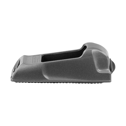 The STANLEY 6 IN SURFORM® POCKET PLANE is a black plastic tool with a sloped, wedge-shaped design, textured surface, and a rear lip—resembling a woodworking tool—displayed against a plain white background.