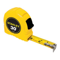 The STANLEY 30 ft Tape Measure features a durable yellow case and sturdy metal blade with precise inch markings, making it an ideal, reliable tool for construction projects.