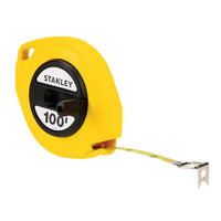 A STANLEY 3/8 in x 100 ft closed case long tape, yellow with a black center, features a metal tape partially extended and a hooked end.