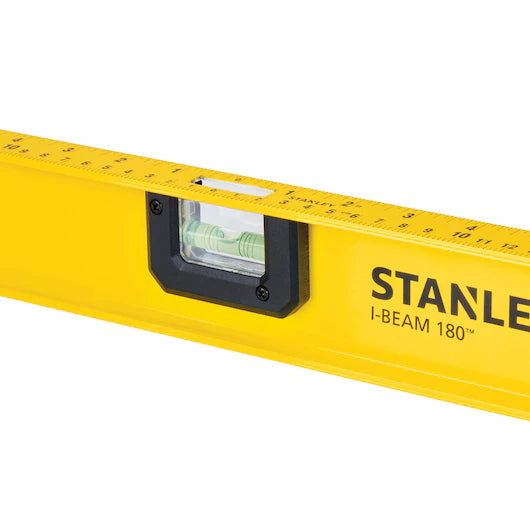 A close-up of a STANLEY 24 in 180° I-Beam Level, a dependable construction tool with a built-in bubble vial and edge ruler markings.
