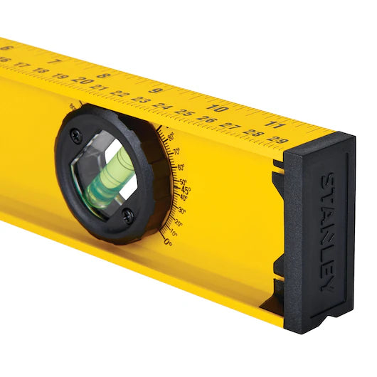 A close-up of the STANLEY 24 in 180° I-Beam Level, a reliable tool for construction. The STANLEY name is embossed on the black end cap, with centimeter measurement markings along the top edge.