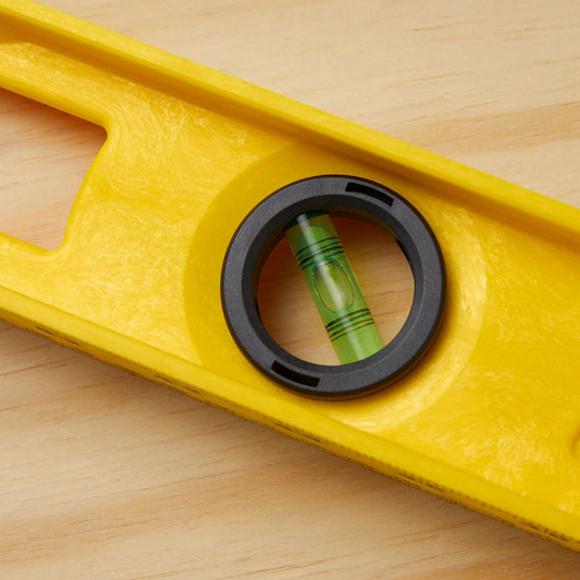 A close-up of the Go Build STANLEY® ABS I-Beam Level 1200mm on wood, featuring a centered bubble in the circular window—showcasing this precise tool by The Fastest Way To Build.