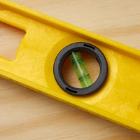 A close-up of the Go Build STANLEY® ABS I-Beam Level 1200mm on wood, featuring a centered bubble in the circular window—showcasing this precise tool by The Fastest Way To Build.