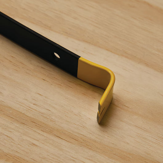 A close-up shows the STANLEY 7 IN WONDER BAR® II PRY BAR with a yellow and black handle on light wood. Made from precision-forged steel, its flat, angled tip has a prying notch for effective demolition tasks.