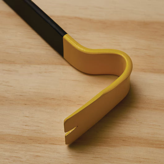 A close-up of the STANLEY 21 IN WONDER BAR® X21 PRY BAR, featuring its curved, flattened end in yellow and black, rests on a wooden surface, emphasizing its strength and effectiveness for demolition tasks.