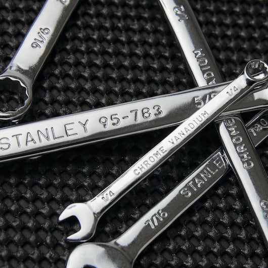 A close-up of the STANLEY COMBINATION WRENCH SET SAE (6 PC) in various sizes, made of chrome vanadium steel, arranged on a textured black surface.
