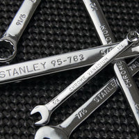 A close-up of the STANLEY COMBINATION WRENCH SET SAE (6 PC) in various sizes, made of chrome vanadium steel, arranged on a textured black surface.