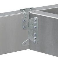 Close-up of a Simpson Strong-Tie S/HJCT-KT galvanized metal corner bracket connecting two aluminum panels. The skewable joist hanger is secured with multiple screws, demonstrating a sturdy joint. The panels have a sleek, brushed metal finish.