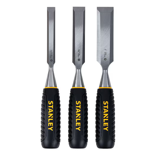 Three STANLEY® WOOD CHISEL 3PC. SET - 13,19,25MM stand upright, each with a black and yellow handle and STANLEY branding in yellow. The set includes precision metal blades in three widths for woodworking tasks.