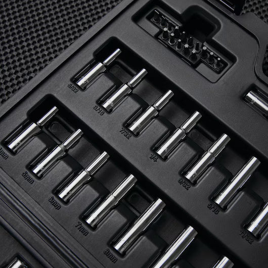 A close-up of a black tool case holding the STANLEY 85PC SKT SET, with chrome vanadium steel bits in assorted sizes, all neatly arranged on a textured dark surface.