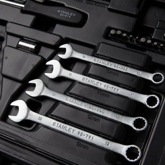 A close-up of the STANLEY 1/4 IN & 3/8 IN DRIVE MECHANIC TOOL SET (145 PC) shows four silver combination wrenches of various sizes, neatly arranged in a black toolkit alongside other tools and accessories.