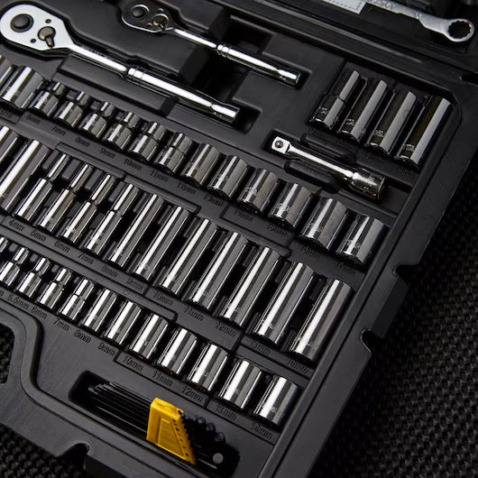 A close-up of the STANLEY 1/4 IN & 3/8 IN DRIVE MECHANIC TOOL SET (145 PC) shows chrome socket wrenches, ratchets, attachments, and hex keys neatly organized in a black case with a yellow-handled tool in the lower corner.