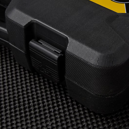 A close-up of a black, textured hard plastic case with a latch, likely containing a STANLEY MECHANIC TOOL SET (201 PC), resting on a black surface. A portion of a yellow label appears on the top right corner of the case.
