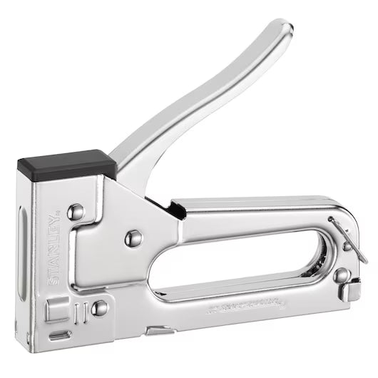 The STANLEY® Light-duty Steel Staple Gun features a shiny silver finish, black tip, and large curved handle. The STANLEY brand is embossed on the side, making it ideal for crafts or light repairs. Shown against a white background.