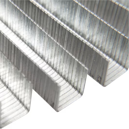 Close-up of several rows of STANLEY® Heavy-duty Staples, 12mm (1,000 PACK), arranged in parallel to display their shiny silver finish and U-shaped design, commonly used as construction fasteners.