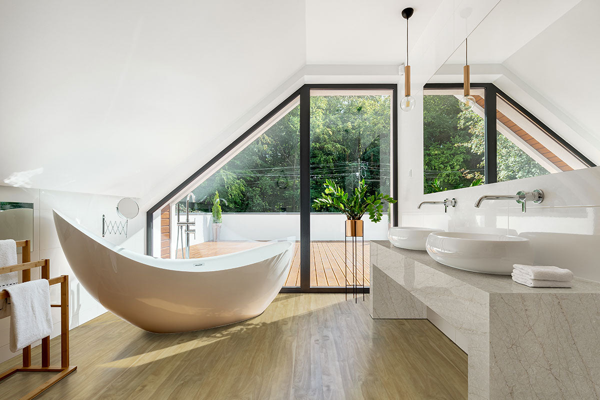Modern bathroom with a sculptural tub, dual vessel sinks on marble, and bright decor. Features MSI Cyrus Brookline Luxury Vinyl Planks (23.77 SQFT/box), offering 100% waterproof, click-lock floating installation for effortless style.