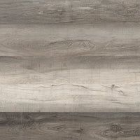 A close-up of the Cyrus Draven Luxury Vinyl Planks by MSI shows gray and brown wood grain with natural variations, knots, and horizontal lines, featuring waterproof CrystaLux protection. (23.77 SQFT per box).