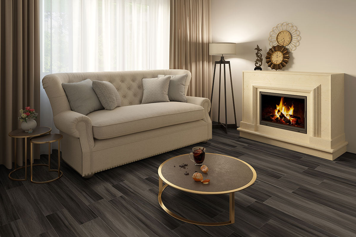 A cozy living room with a beige sofa, gray cushions, coffee table, fireplace, and lamp features MSIs Cyrus Jenta Luxury Vinyl Planks flooring (23.77 SQFT/box), offering waterproof SPC core durability and a stylish dark wood look.