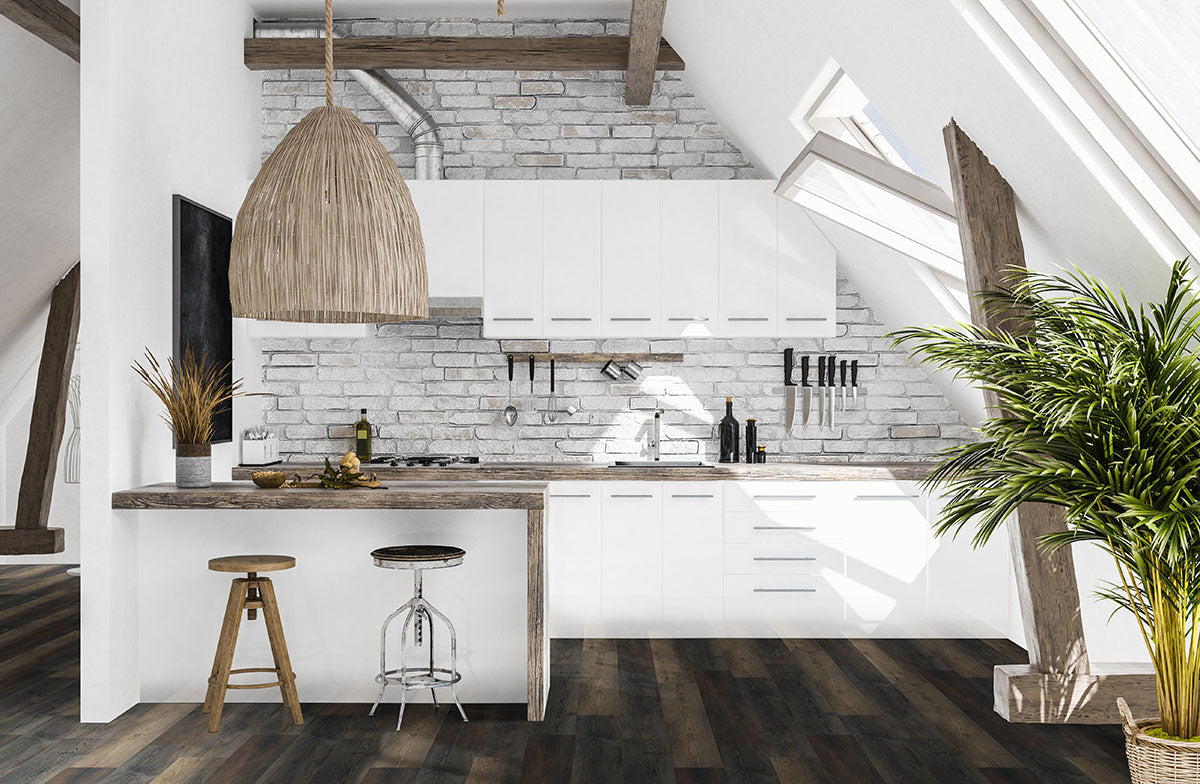 Modern attic kitchen with white cabinets, brick backsplash, and wood beams features MSI Cyrus Stable Luxury Vinyl Planks (waterproof SPC core). Rustic pendant light, bar stools, and a large green plant create a bright, airy vibe.