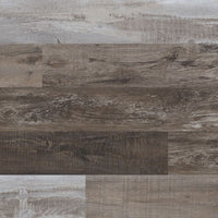 Close-up of MSI Cyrus Weathered Brina Luxury Vinyl Planks (23.77 sqft box) in varied brown and gray tones, featuring a rustic wood look with realistic grain. These planks are 100% waterproof, durable, and easy to install.