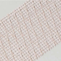 A close-up of ADFORS FibaTape FDW8666-U 2-3/8 in. x 250 ft. Extra Strength Reinforced Drywall Tape with a crisscross grid pattern in light pink, shown diagonally on a light grey surface, perfect for drywall seam reinforcement.