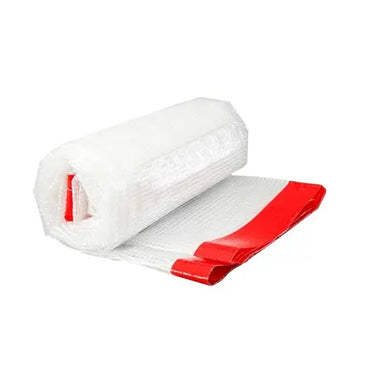 The Grip-Rite 20 ft. x 100 ft. 6 Mil Reinforced Poly Sheeting unrolls to reveal its durability, ideal for commercial use. A distinctive red edge enhances visibility throughout the roll, which stands out against a plain white background.