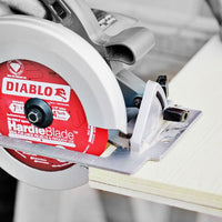 A circular saw with the DIABLO D0604DHA 6-1/2 in. x 4 Tooth (PCD) Fiber Cement Hardie Saw Blade by Diablo smoothly slices through wood, showcasing skillful woodworking and precision for James Hardie Building Products.