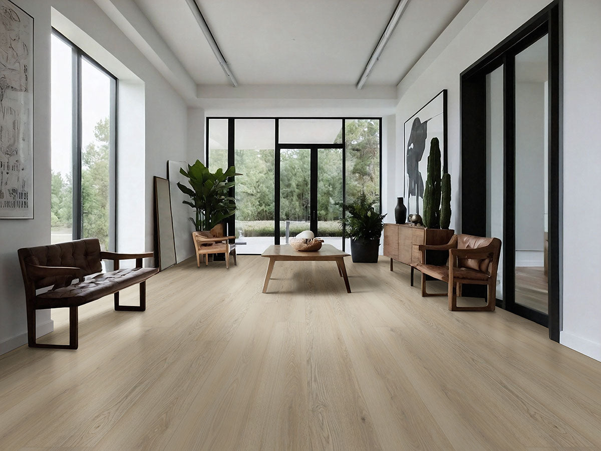 A modern living room features MSI XL Cyrus Austell Grove Luxury Vinyl Planks, brown leather chairs, a wood coffee table, potted plants, large windows with green views, and minimal wall art. Natural light fills the neutral, airy space.