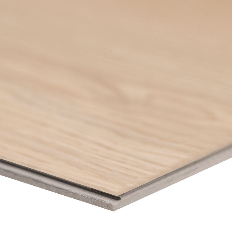 A close-up of the edge of an MSI XL Cyrus Austell Grove Luxury Vinyl Plank shows its DIY-friendly click-lock system and light, neutral blonde wood-look finish with natural grain detail. Each box covers 22.44 sq ft.