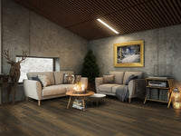 Modern cozy living room with concrete walls, MSI XL Cyrus Barrell Luxury Vinyl Planks flooring, beige sofas, a round coffee table with candles, Christmas tree, window, deer sculpture, record player, and a framed winter landscape painting.