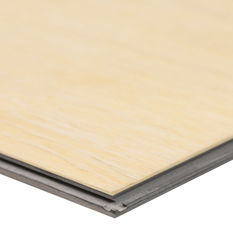 A close-up of the edge of an MSI XL Cyrus Lenexa Creek Luxury Vinyl Plank BOX (22.44 SQFT) showcases its layered build and interlocking tongue-and-groove beneath a durable CrystaLux™ wear layer.