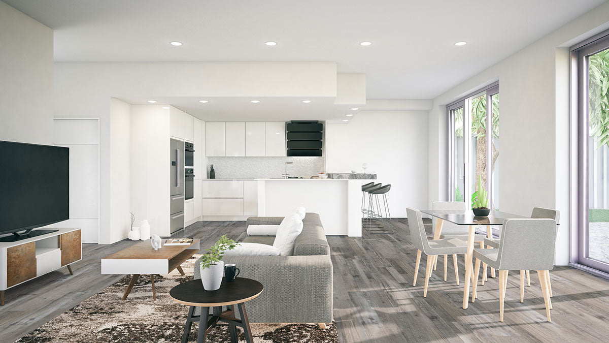 Modern open-plan living space featuring a grey sofa, coffee table, TV, dining area with glass table and four chairs, and a white kitchen with bar stools. Large windows highlight MSI XL Cyrus Mezcla Luxury Vinyl Planks flooring.