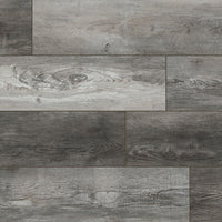 A close-up of MSI XL Cyrus Boswell Luxury Vinyl Planks BOX (22.44 SQFT) shows rectangular tiles in an offset pattern, displaying gray and brown wood-look tones with realistic grain and knot details for a weathered aesthetic.