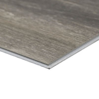 A close-up of an MSI XL Cyrus Bracken Hill Luxury Vinyl Plank highlights its thin profile, wood-like gray-brown texture, and CrystaLux™ protective finish for enhanced durability. Each box covers 22.44 sq ft.