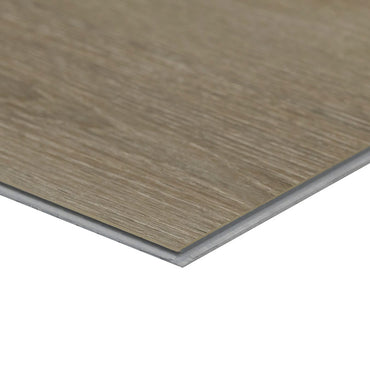 A close-up of an MSI XL Cyrus Cranton Luxury Vinyl Plank (22.44 sq ft) shows its thin, rectangular shape, wood grain texture, light brown color, layered edge detail, and 100% waterproof construction.