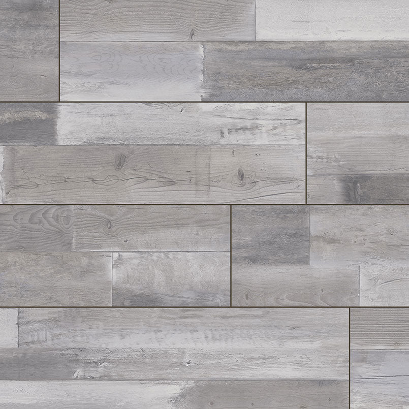 A close-up of MSIs XL Cyrus Woburn Abbey Luxury Vinyl Planks BOX (22.44 SQFT), featuring waterproof, rectangular plank-style tiles in gray tones with realistic wood grain and natural patterns for an authentic look.